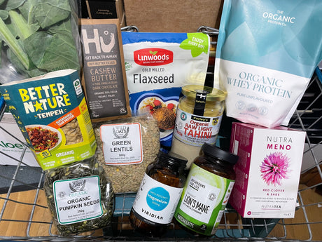 Shopping basket with Catherine’s top hormone health picks, including seeds, lentils, tahini, chocolate, supplements, and herbal tea.