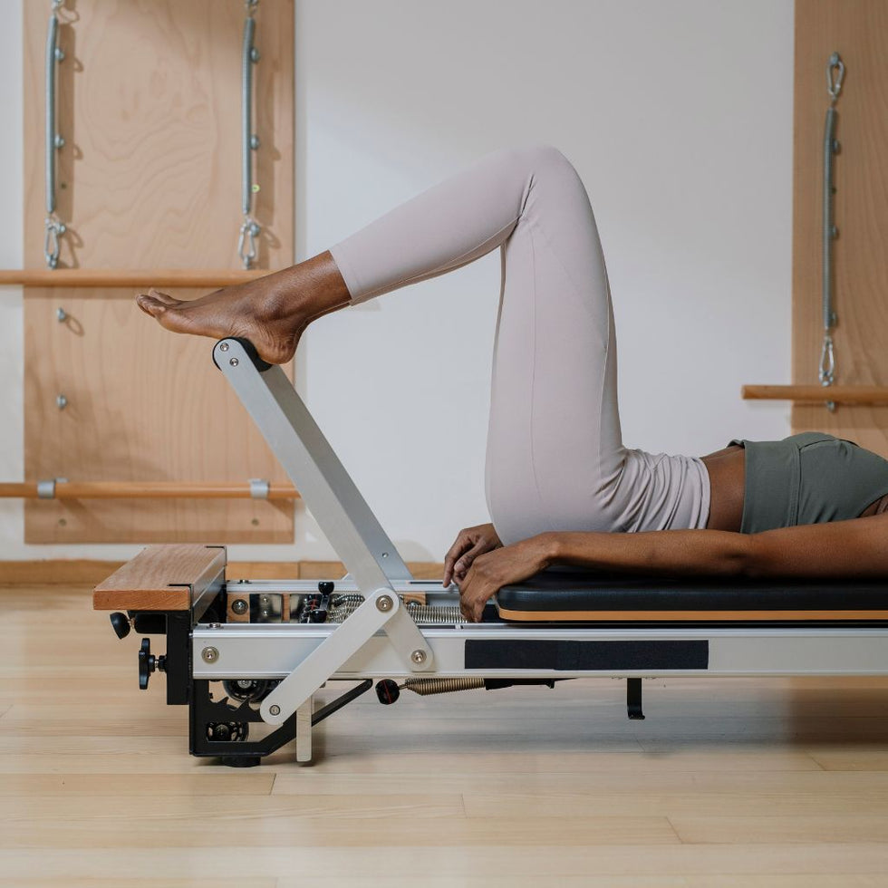 Woman using Pilates equipment in a Bristol Pilates class