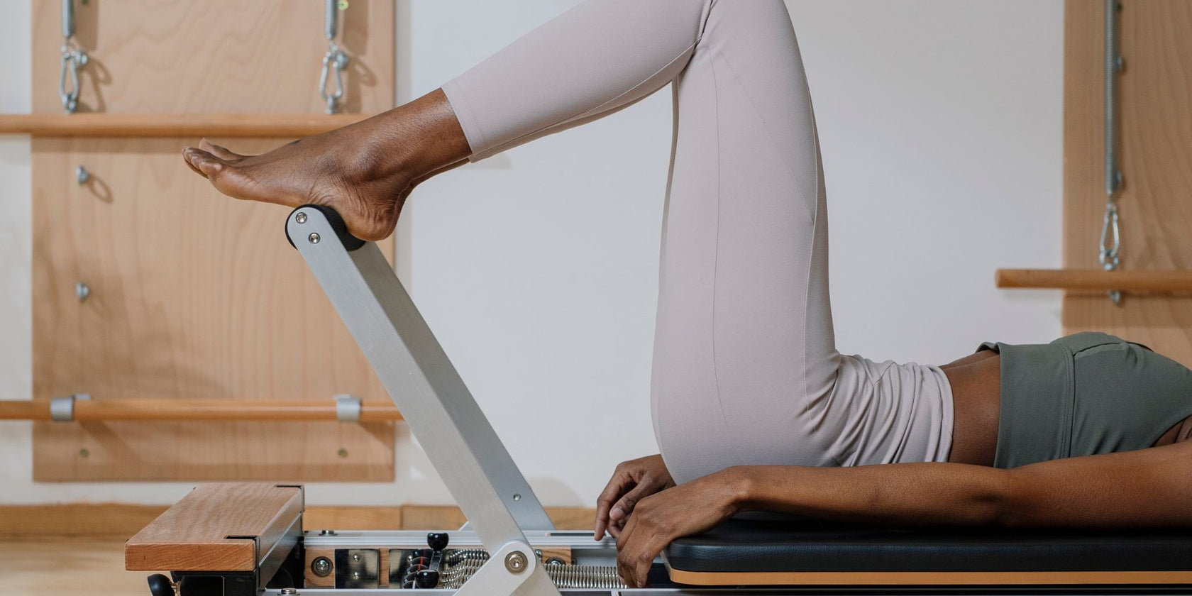 Woman using Pilates equipment in a Bristol class